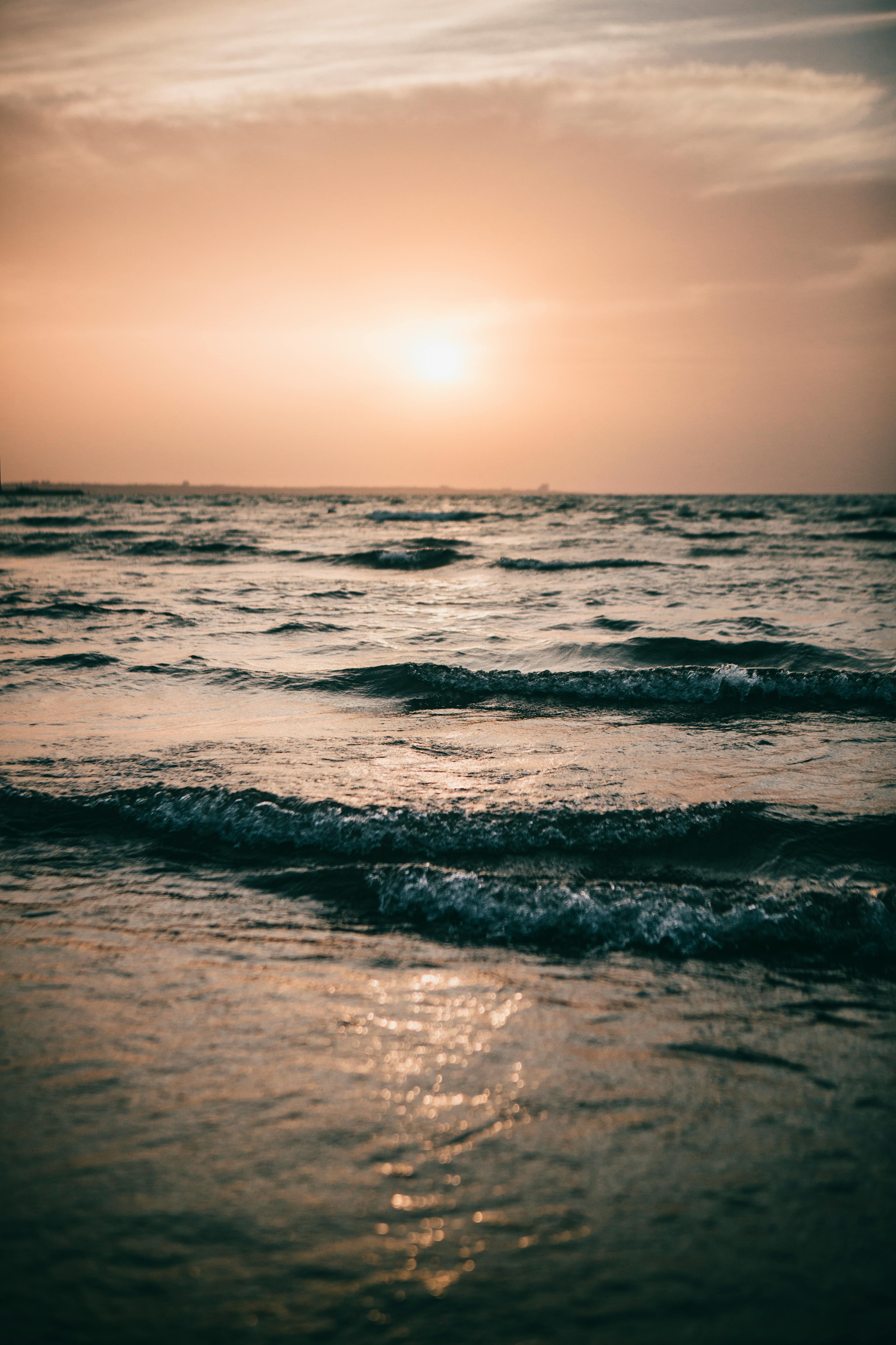 Ocean Waves Crashing On Shore During Sunset Free Stock Photo