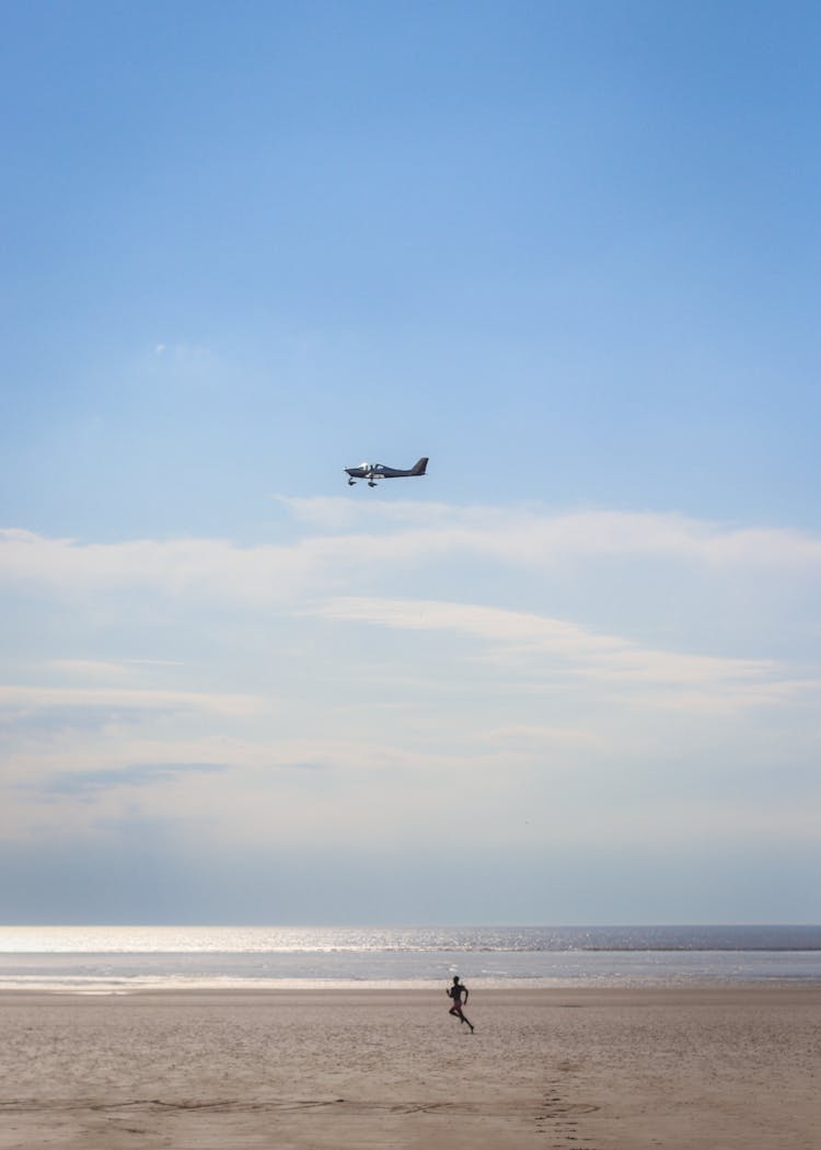 Plane Flying Over The Sea