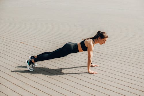 A Woman in Activewear Doing a Push Up