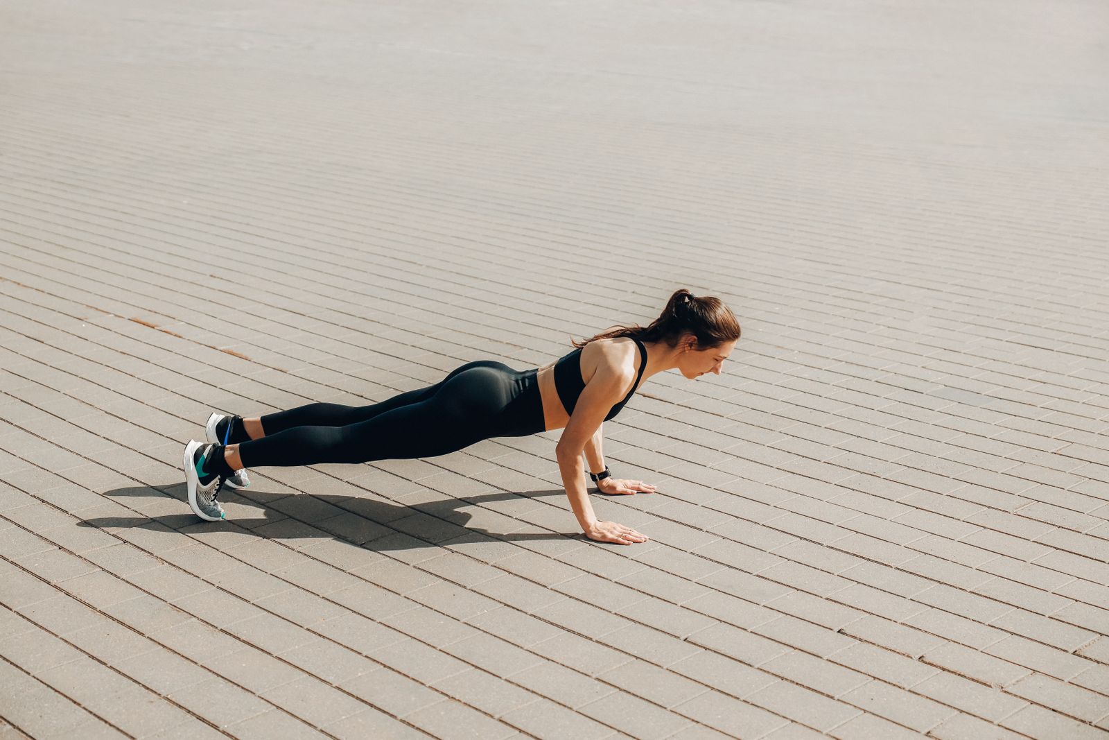 Instructor demonstrating a bodyweight interval training move