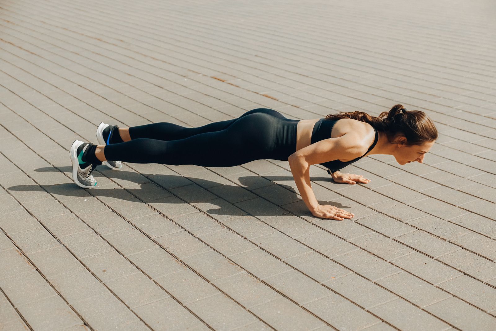 Person doing a short, high-intensity home workout session in a compact living room space