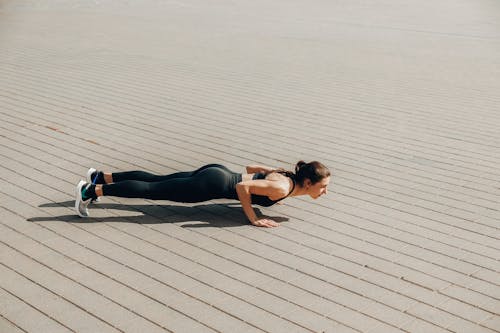 A Woman in Activewear Doing Push Ups