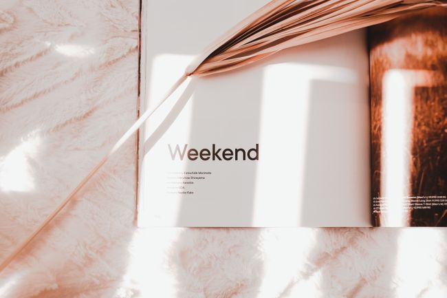 Open magazine spread in raking daylight — photo by Valeriia Miller on Pexels