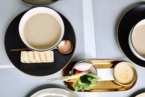 Top View of Soup with the Side of Vegetables Served on the Table 