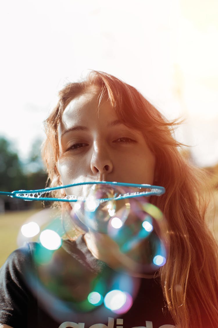 Photo Of A Woman Blowing Bubbles