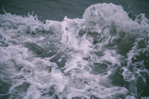 Close-Up Photo of Sea Water with Foam