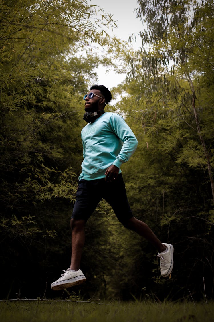 Man In Headphones Running In Park