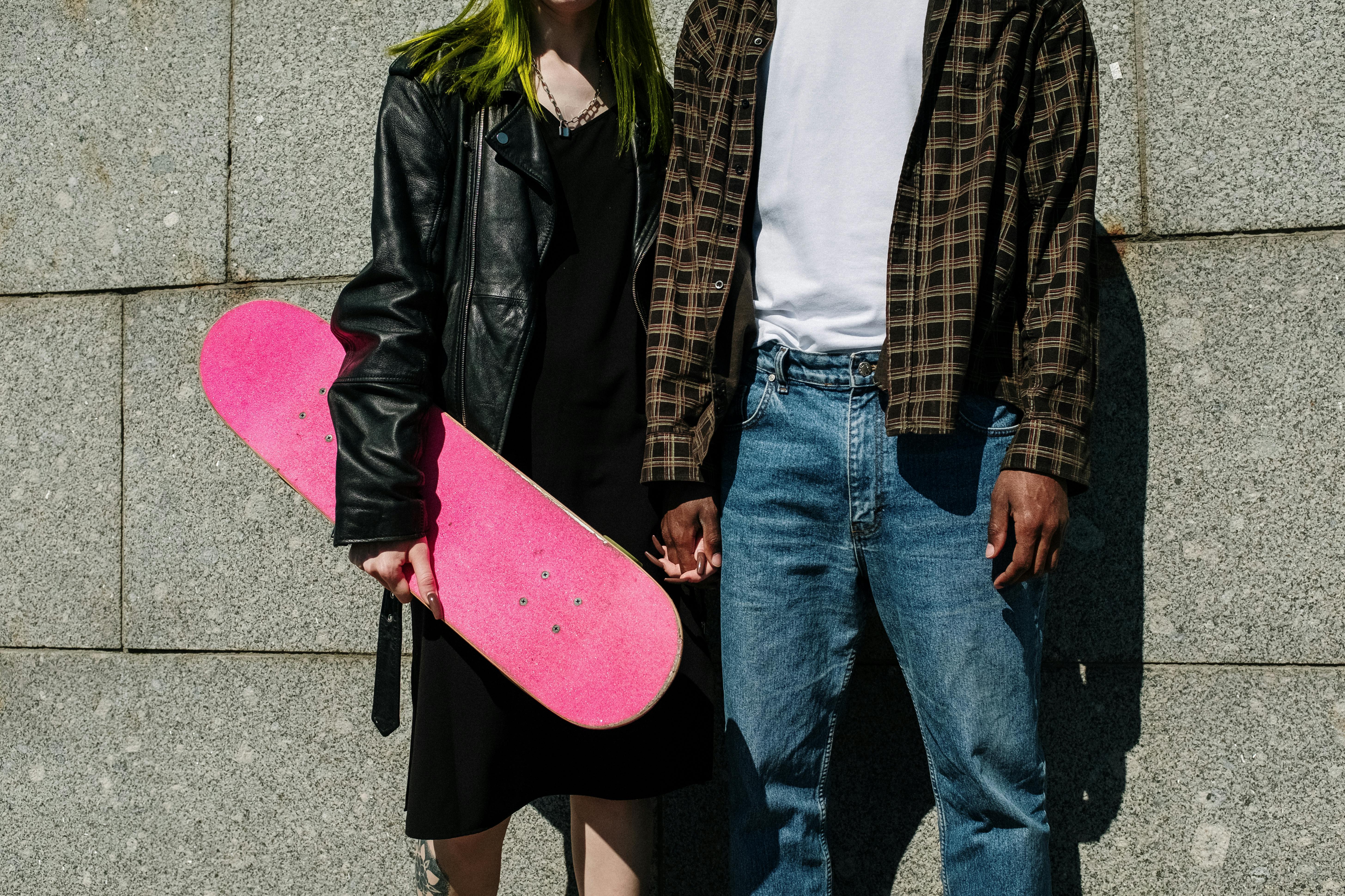 man in black leather jacket standing beside woman in black jacket