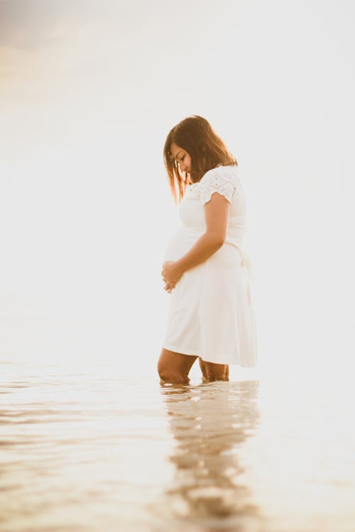 Pregnant Woman in White Dress