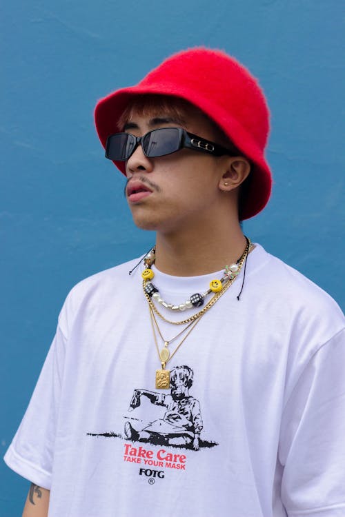 Photo of a Man with Black Sunglasses Wearing a Red Bucket Hat