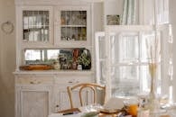 White Wooden Cabinet Near Dining Table