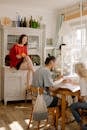 Woman in Blue Shirt Sitting on Chair Beside Woman in Red Shirt