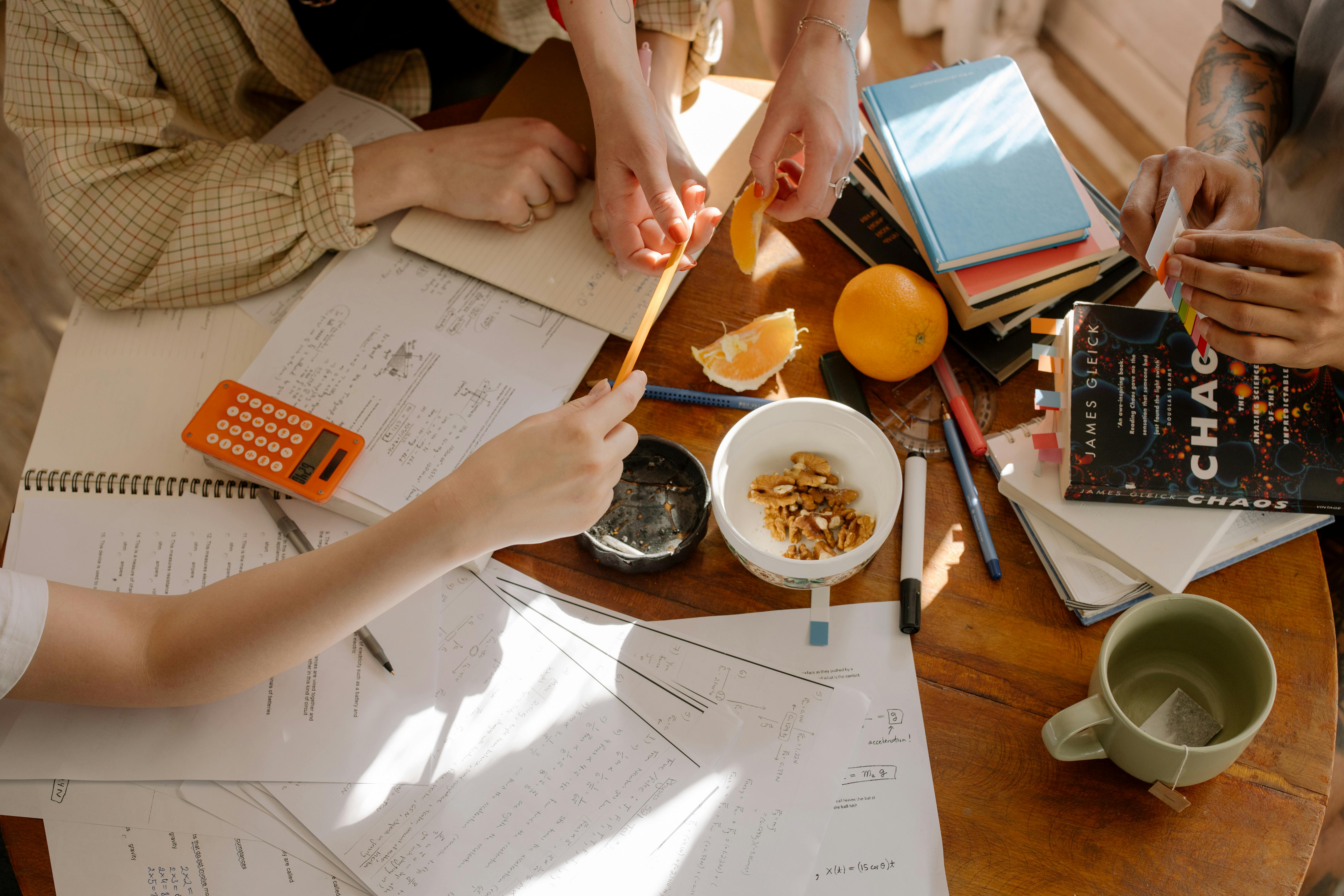 person holding brown chopsticks and white ceramic bowl