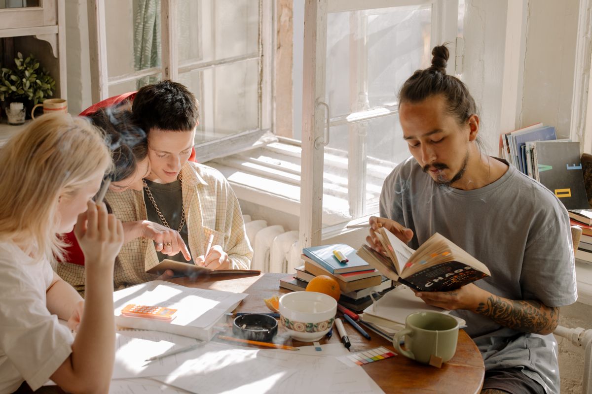 Group of college students studying together in a bright room with natural light