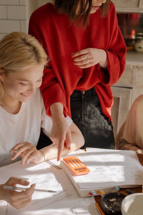 Girl in White Crew Neck T-shirt Writing on White Paper