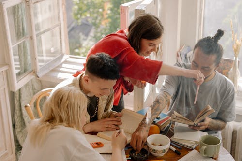 Woman in Red Long Sleeve Shirt Holding a Girl in White Long Sleeve Shirt