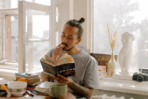 Woman in Gray Crew Neck Shirt Holding Book