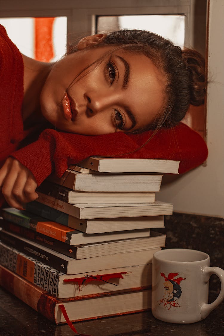Woman Leaning On A Pile Of Books