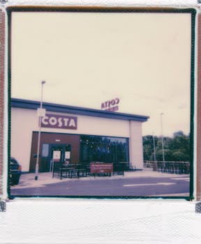 Exterior view of a Costa coffee shop with ample copy space above.