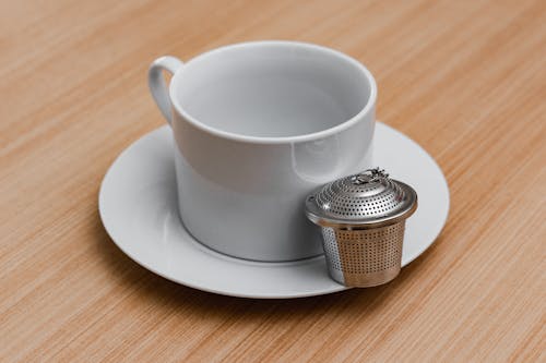 Free A White Mug Beside a Silver Infuser Stock Photo