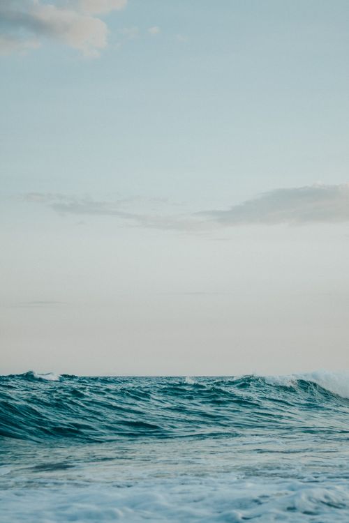 Free Serene image of ocean waves with a clear sky, perfect for peaceful and natural themes. Stock Photo