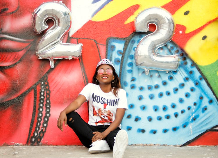 Stylish Black Woman Near Bright Graffiti Wall With Numbers