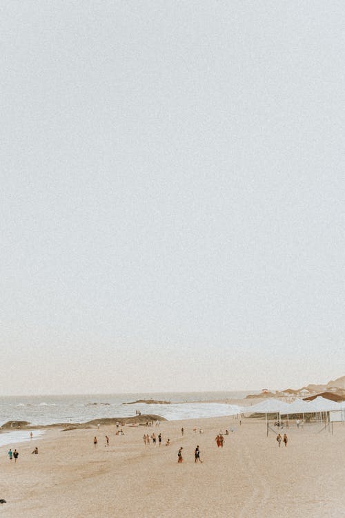 Photograph of People at the Beach with Sand