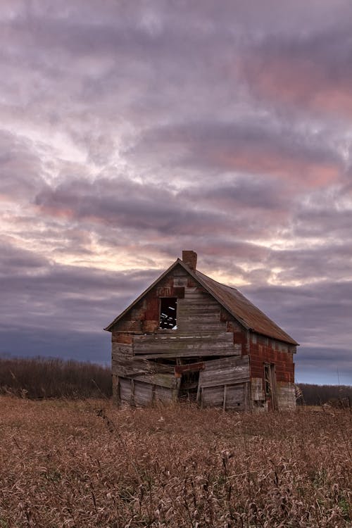 Photograph of an Abandoned Barn on a Field