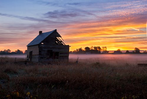 Photo of an Abandoned Barn During Sunrise