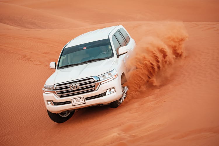 Man Driving A Land Cruiser On The Desert