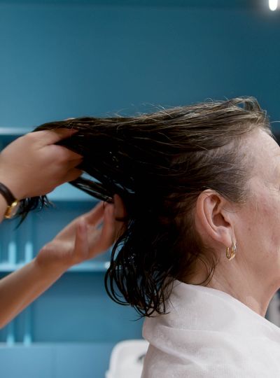 Stylist applying color with focused attention to detail