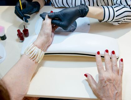 Manicure in progress, polish being applied