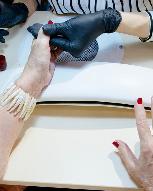 Manicure in progress, polish being applied