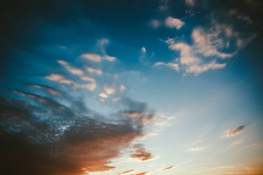 From below scenic view of sky with bright stratus clouds at sundown