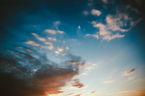 Free From below scenic view of sky with bright stratus clouds at sundown Stock Photo