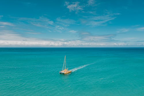 Yellow Boat on Turquoise Sea and Horizon