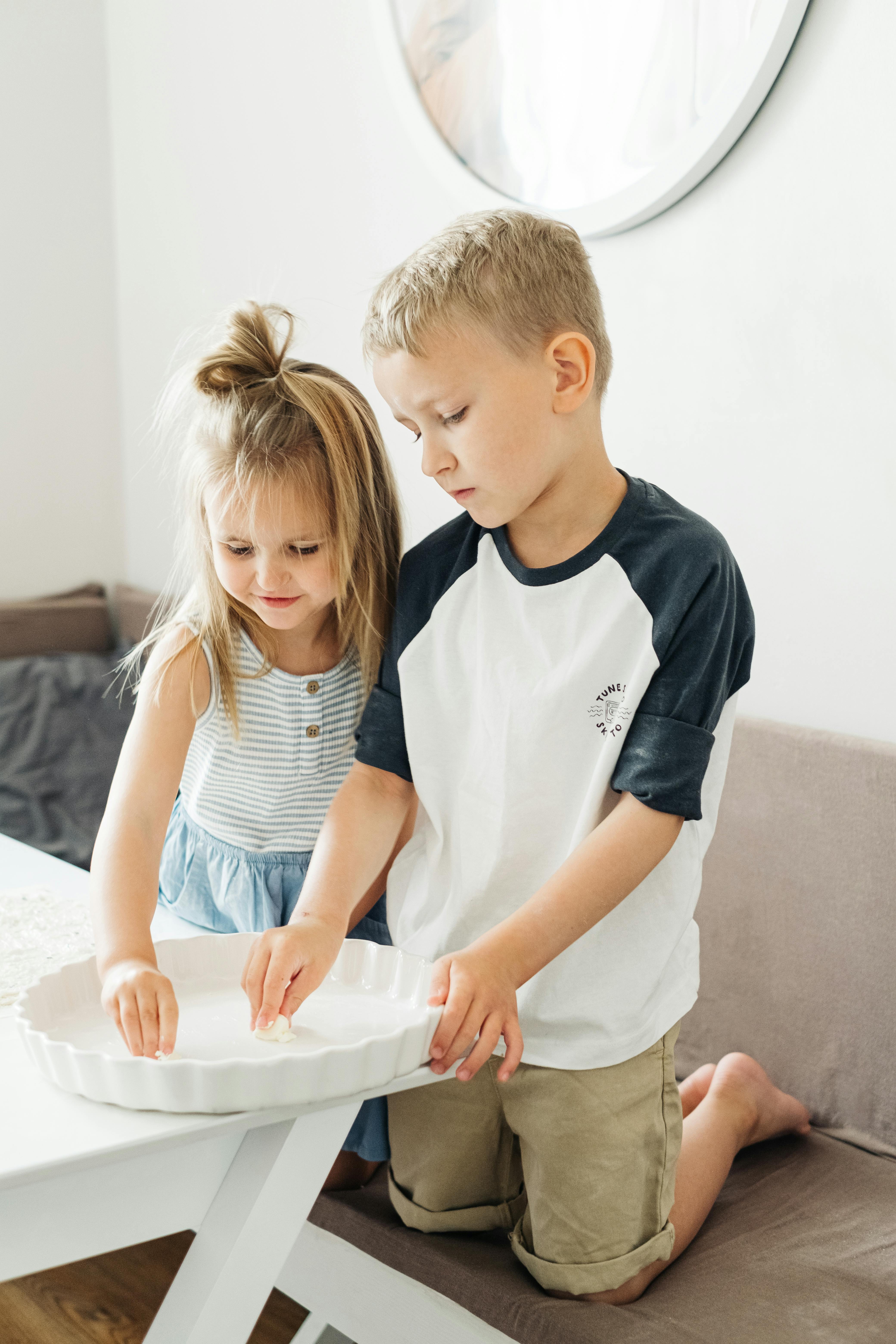 boy in white and black crew neck t shirt beside girl in white t shirt