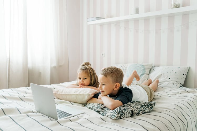 Kids Lying On The Bed 