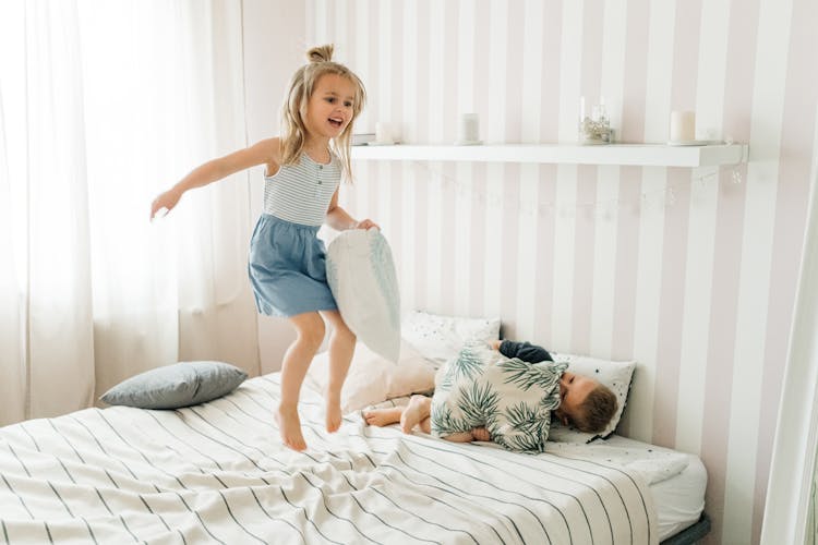 Girl Jumping On The Bed