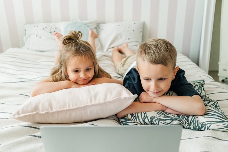 Siblings Watching On A Laptop