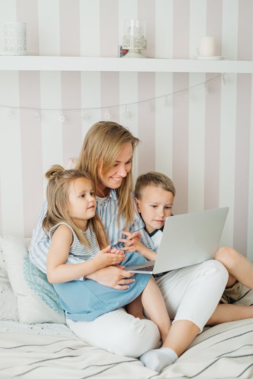 Mother and Her Children Watching on Laptop