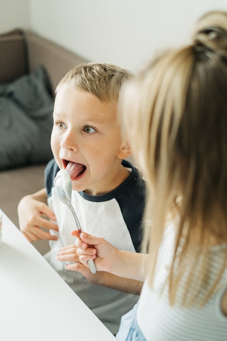 Boy Licking A Spoon