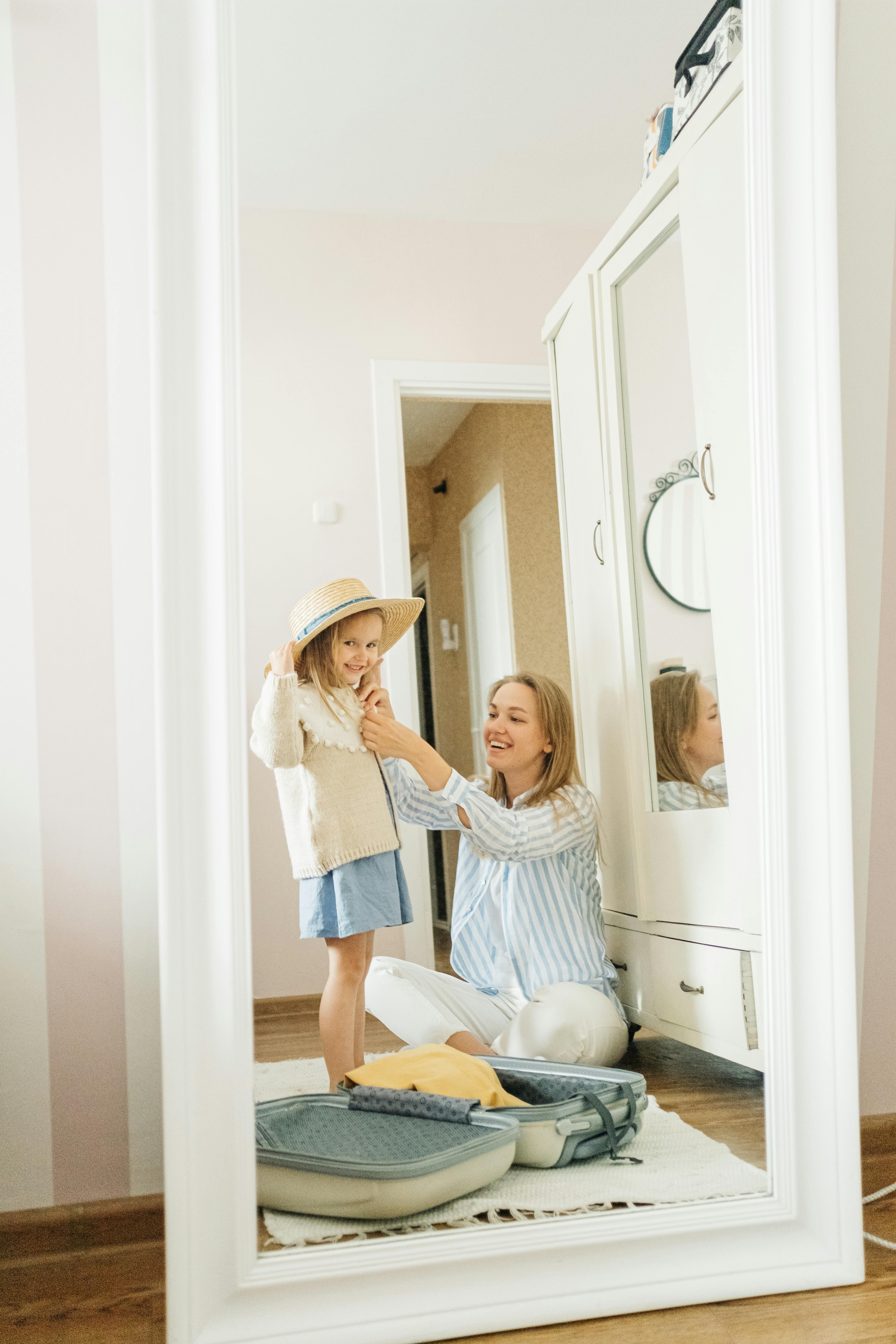 woman in white long sleeve shirt and blue denim jeans standing beside white wooden door