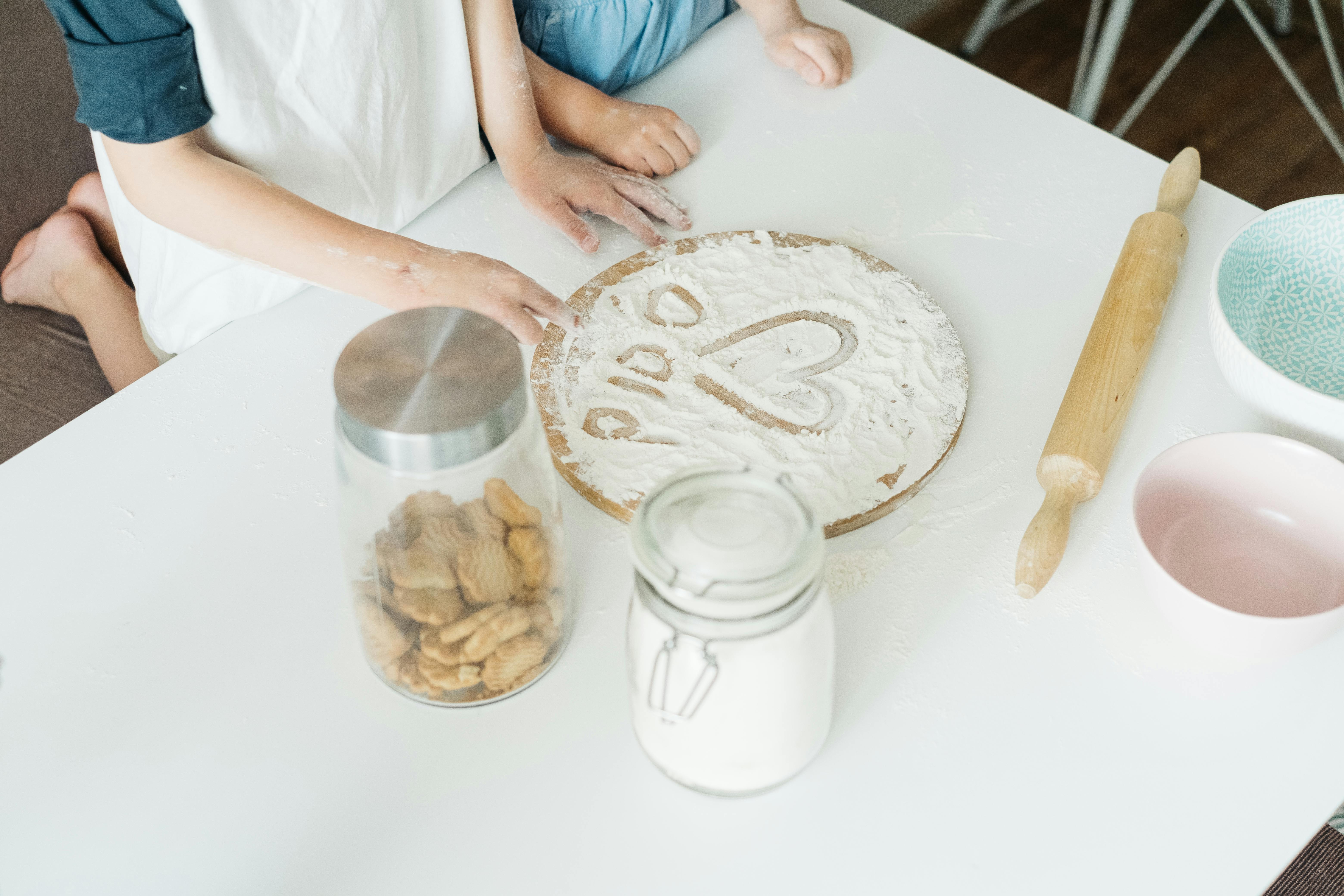 person holding brown wooden rolling pin