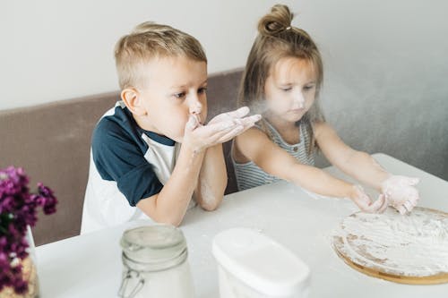 A Boy Blowing Off Flour on His Hands