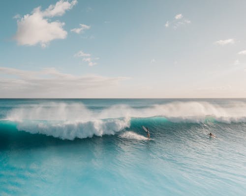 People Surfing on Big Waves on Sea