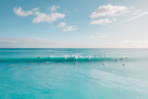 Free People Surfing on the Sea Stock Photo