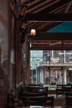 Warm, inviting restaurant interior with rustic charm and wine bottles on display.