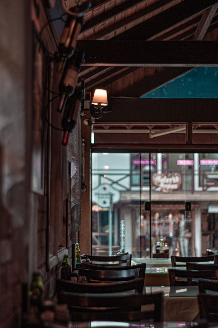 Warm rustic counter and wine bottles — photo by Luis Fernandes on Pexels