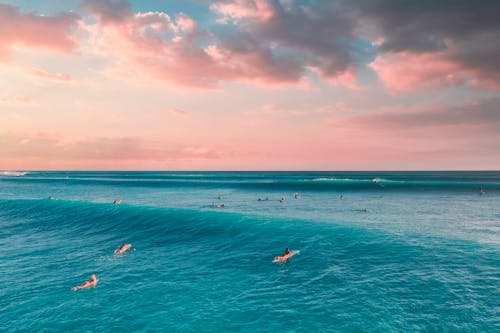 People Surfing on  the Beautiful Sea